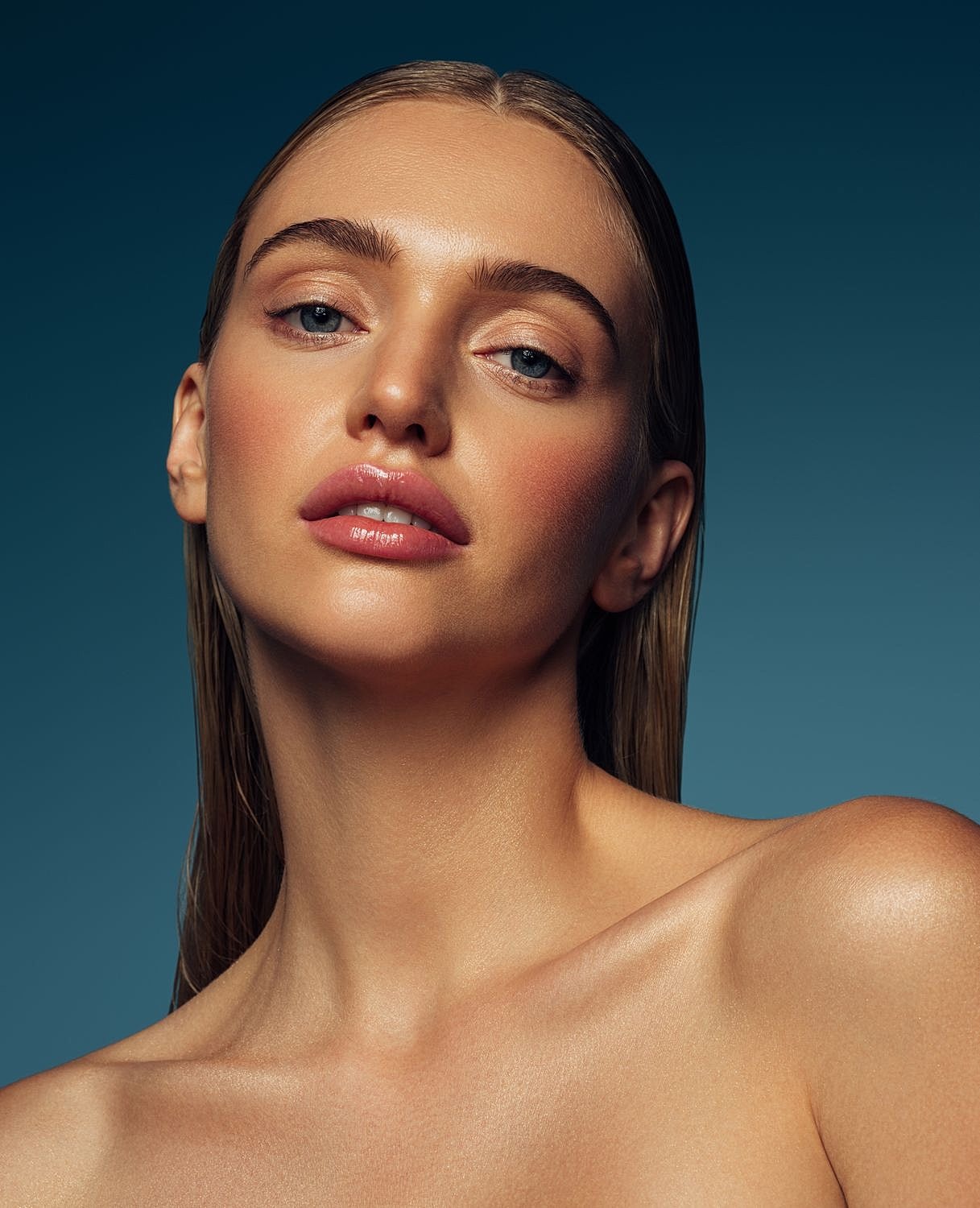 Close-up of a woman with glowing skin.