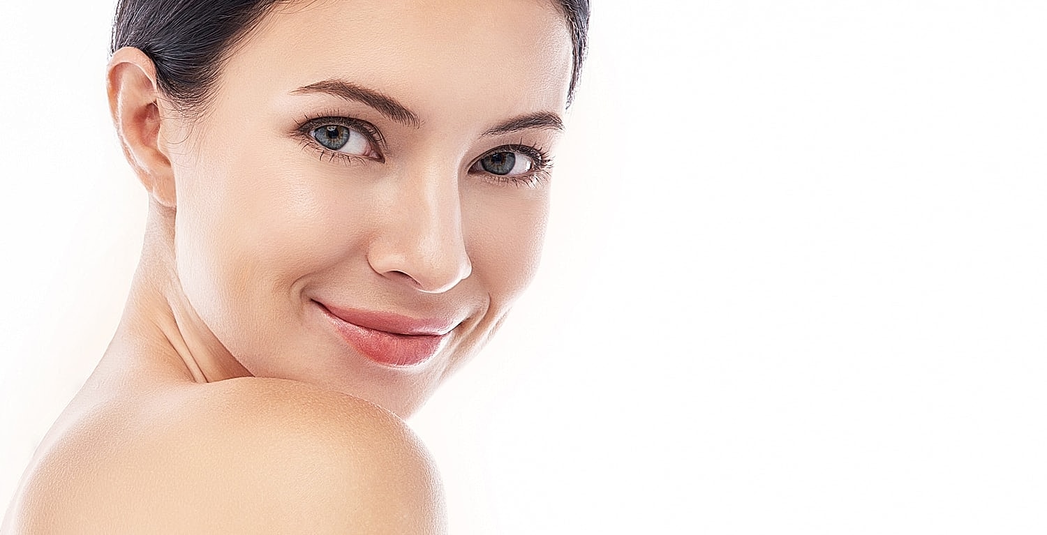 Smiling woman with clear skin and dark hair.