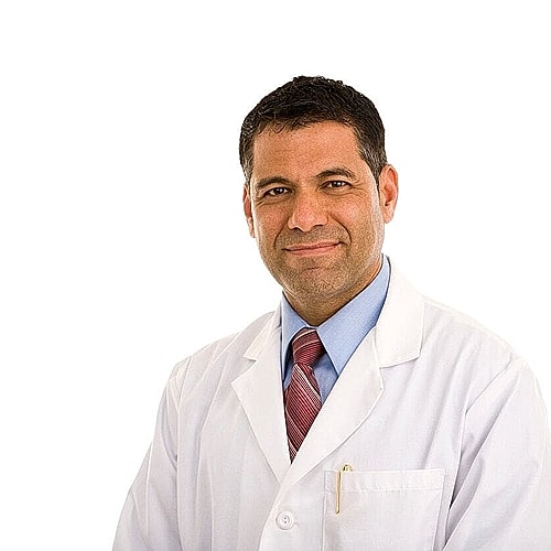 Male doctor smiling in a white lab coat.